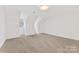 Spacious attic room with neutral carpet, white trim, and angled ceilings at 1441 Carmel Rd, Charlotte, NC 28226