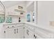 This wet bar area features white cabinets, shelving, and a sleek black faucet at 1441 Carmel Rd, Charlotte, NC 28226