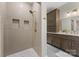 This bathroom boasts a tiled shower with built-in niches and a vanity with storage at 1441 Carmel Rd, Charlotte, NC 28226