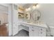 Bathroom features white vanity with double sinks, ample storage, and gold-framed mirrors at 1441 Carmel Rd, Charlotte, NC 28226