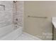 Bright bathroom featuring a tub with shower and subway tile surround at 1441 Carmel Rd, Charlotte, NC 28226