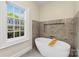 A serene bathroom with a soaking tub and large window bringing in natural light at 1441 Carmel Rd, Charlotte, NC 28226