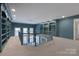 Large bonus room with built-in bookcases and a chandelier at 1441 Carmel Rd, Charlotte, NC 28226