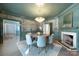 Dining room featuring a chandelier, decorative wallpaper, fireplace, and wood flooring at 1441 Carmel Rd, Charlotte, NC 28226