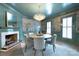 An elegant dining room featuring designer wallpaper, a fireplace and a crystal chandelier at 1441 Carmel Rd, Charlotte, NC 28226