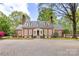 Stately brick home featuring dormer windows, a brick chimney and a large brick-paved driveway at 1441 Carmel Rd, Charlotte, NC 28226
