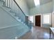 Bright foyer features a staircase, skylight, wood flooring and a paneled wood front door at 1441 Carmel Rd, Charlotte, NC 28226