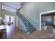 A wide and bright foyer with a staircase leads to adjacent dining and living rooms at 1441 Carmel Rd, Charlotte, NC 28226