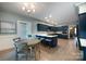 An open-concept kitchen boasting an island with barstool seating and stainless steel appliances at 1441 Carmel Rd, Charlotte, NC 28226