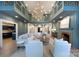 A large living room with a fireplace, chandelier, and open access to other rooms at 1441 Carmel Rd, Charlotte, NC 28226