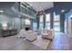 Spacious living room with a fireplace, high ceilings, and plenty of natural light at 1441 Carmel Rd, Charlotte, NC 28226