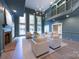 Sun-filled living room boasting large windows, a fireplace, and a second-story balcony at 1441 Carmel Rd, Charlotte, NC 28226