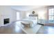 This primary bedroom has great natural light with a fireplace and hardwood floors at 1441 Carmel Rd, Charlotte, NC 28226
