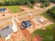 Wide aerial capture of a new housing construction site, set against verdant trees at 1504 Baileys Run, Gastonia, NC 28056