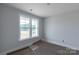 Simple bedroom showcasing a bright window and neutral wall color at 1504 Baileys Run, Gastonia, NC 28056