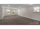 Spacious bonus room featuring neutral paint and carpet with abundant natural light from double hung windows at 1504 Baileys Run, Gastonia, NC 28056