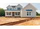 Charming two-story home featuring a welcoming front porch, stylish shutters, and a neatly landscaped yard at 1504 Baileys Run, Gastonia, NC 28056