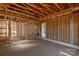 Wood framing reveals the interior with natural light and exposed beams, ready for customization and completion at 1504 Baileys Run, Gastonia, NC 28056