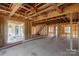 Wood framing reveals the interior with natural light and exposed beams, ready for customization and completion at 1504 Baileys Run, Gastonia, NC 28056