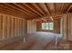 Wood framing reveals the interior with natural light and exposed beams, ready for customization and completion at 1504 Baileys Run, Gastonia, NC 28056