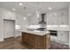 Modern kitchen with stainless steel appliances, custom cabinetry, large island, and pendant lighting at 1504 Baileys Run, Gastonia, NC 28056