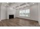 Bright living room with coffered ceilings, wood floors, modern fireplace, and large windows at 1504 Baileys Run, Gastonia, NC 28056