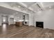 Spacious living room featuring a coffered ceiling, wood floors, and a modern fireplace at 1504 Baileys Run, Gastonia, NC 28056