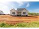 The rear of a new home under construction, showing the framing and spacious backyard at 1504 Baileys Run, Gastonia, NC 28056