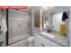 Modern bathroom featuring granite counters, glass-enclosed shower, and decorative light fixtures at 156 Asmodean Ln, Troutman, NC 28166