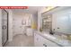 Well-lit bathroom featuring double vanities, granite counters, and a glass-enclosed shower at 156 Asmodean Ln, Troutman, NC 28166