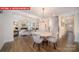 Open concept view of the dining room with a hardwood floor and views to the kitchen and living room at 156 Asmodean Ln, Troutman, NC 28166