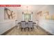 Elegant dining room with wainscotting and an ornate chandelier above the table at 156 Asmodean Ln, Troutman, NC 28166