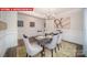 Elegant dining room with modern decor and wainscotting at 156 Asmodean Ln, Troutman, NC 28166