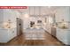 Bright, open kitchen features white cabinets, stainless steel appliances, and a large center island with seating at 156 Asmodean Ln, Troutman, NC 28166