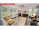 Cozy living room featuring large windows, a fireplace, and stylish furniture at 156 Asmodean Ln, Troutman, NC 28166