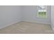 A bright, carpeted bedroom with ample natural light and neutral decor at 187 Longleaf Dr, Mooresville, NC 28117