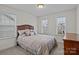 Cozy bedroom featuring carpet floors, natural light, and a comfortable bed with decorative pillows at 187 Longleaf Dr, Mooresville, NC 28117