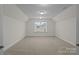 Spacious bonus room with neutral carpet, recessed lighting, and a window providing plenty of natural light at 187 Longleaf Dr, Mooresville, NC 28117