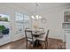 Bright breakfast nook with a modern chandelier, view of the backyard, and seating for four at 187 Longleaf Dr, Mooresville, NC 28117