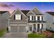 Charming two-story home with a manicured lawn, a two-car garage, and inviting front porch at 187 Longleaf Dr, Mooresville, NC 28117