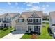 Charming two-story home featuring a welcoming front porch, a two-car garage, and nicely landscaped front yard at 187 Longleaf Dr, Mooresville, NC 28117