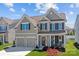 Beautiful two-story home featuring a manicured lawn, two-car garage, and welcoming front porch at 187 Longleaf Dr, Mooresville, NC 28117