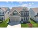 Charming two-story home featuring a welcoming front porch, a two-car garage, and nicely landscaped front yard at 187 Longleaf Dr, Mooresville, NC 28117