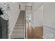 Open floor plan with foyer leading to living spaces with wood floors and staircase with wood railing at 187 Longleaf Dr, Mooresville, NC 28117