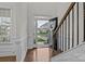 Bright foyer features wood floors, an elegant staircase, and a view of the well-maintained front yard at 187 Longleaf Dr, Mooresville, NC 28117