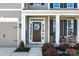 Charming covered porch features rocking chairs and beautiful landscaping, with a two-car garage to the side at 187 Longleaf Dr, Mooresville, NC 28117