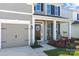 Inviting front porch with rocking chairs, lovely landscaping, and a two-car garage on a charming home at 187 Longleaf Dr, Mooresville, NC 28117