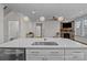 Features an undermount sink, stainless steel appliances, and leads to a living area with a stone fireplace at 187 Longleaf Dr, Mooresville, NC 28117