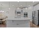 Modern kitchen with white cabinets, stainless steel appliances, large island, and pendant lighting at 187 Longleaf Dr, Mooresville, NC 28117