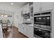 Modern kitchen with stainless steel appliances, white cabinetry, and an adjacent breakfast nook at 187 Longleaf Dr, Mooresville, NC 28117